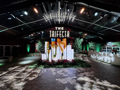 A custom-lit “The Trifecta” sign served as the event space’s centerpiece in a nod to the company that hosts the event, which is headed by retired NBA guard Ulysses Lee “Junior” Bridgeman and his family, including his three children. The sign’s neon lighting was reflected onto the tent’s ceiling for an added, awe-inspiring lighting effect.
