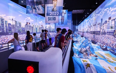 Visitors start the journey by joining the World Cup victory parade as they walk through an entrance designed to resemble an open-top bus that’s passing by thousands of cheering fans.