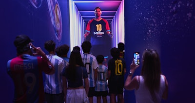 An AI chatbot version of Messi greets visitors.