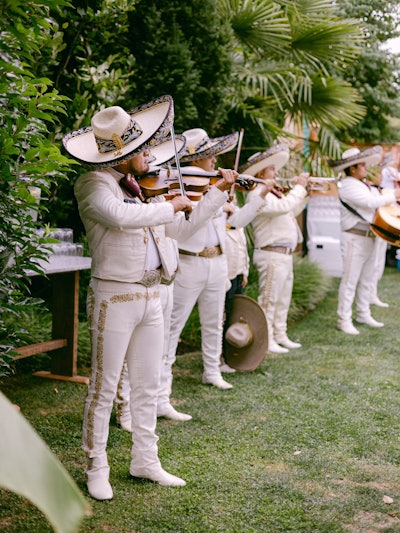 'Musical performances that roam in between rooms also have a way of drawing guests' attention and guiding them into a new space,' adds Valley. 'Other playful ways of movement have been roaming stilt walkers who reveal a new space behind tall curtains, a hazy smoke entrance reveal, and a flower wall that separates to reveal a magical dinner.”