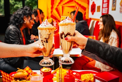 The Deluxe Cheez-It Milkshake was a vanilla shake blended with Cheez-It crackers; served with a caramel and crushed Cheez-It cracker rim; topped with whipped cream, sprinkles, and chocolate sauce; and garnished with a chocolate-dipped Cheez-It cracker.
