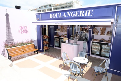 Highlights included an Emily in Paris boulangerie featuring branded bread loaves, coffees, and pastries transporting attendees into the world of the hit series. By night, the space became a Champagne and oyster bar.