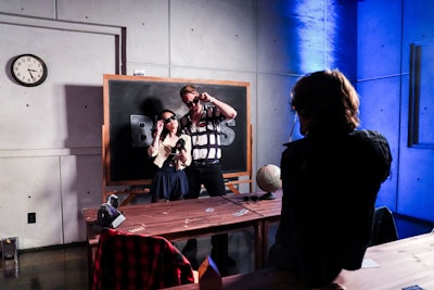 One room featured scenes from The Breakfast Club, including the graffitied red lockers and the Shermer High detention hall with desks carved with each character’s name, themed props, and letterman jackets.