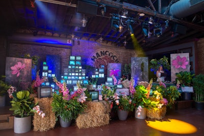 The back room, which is typically a restaurant and sports bar, featured a stage where Fig Media DJ Megan Taylor spun. Decorated with hay bales and prairie flowers, the setup also had towers of vintage TVs that showcased past Joffrey performances and a live feed from the event. “My design process was that there were already so many TVs in the room, and I wasn't going to be able to disguise them, so I wanted to double down!” Williquette says. “If you can't beat them, join them, and make it art.”