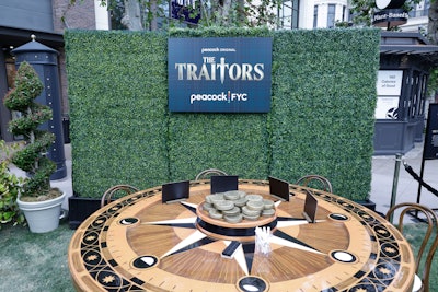 To start the day, fans could board 'The Traitors Trolley' at the Farmers Market, which dropped them off at the pop-up. On site, they could test their knowledge at “Faithful Fan Trivia,” play “Meme Bingo” featuring The Traitors season two’s most memorable scenes, and take “The Traitor Test,' a polygraph game that designated them as a traitor or a faithful. There were also photo ops in front of the show's portrait wall or at the roundtable, plus a themed snack bar that offered a choice between traitor and faithful menus featuring iced tea and cookies.