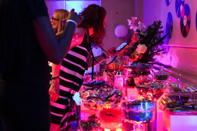 A candy bar featured a selection of sweets in a listening room with vintage record players, records, and headphones for guests to enjoy, along with custom art inspired by the documentary.