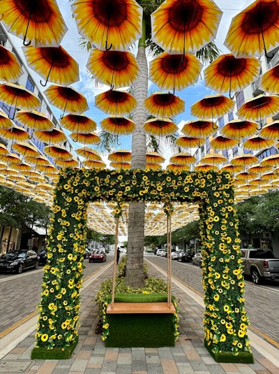 CityPlace Doral—a dining and entertainment destination in South Florida—hosted a seasonal Instagrammable art installation made entirely of sunflower-decorated umbrellas last month. Upon entering the center, guests were welcomed with 1,300 sunflower-decorated umbrellas floating overhead on the boulevard; the shade-providing umbrellas were arranged so the sunflowers were visible from both the top and bottom.