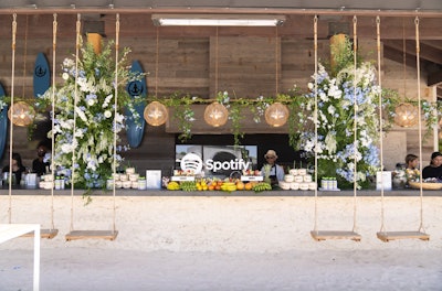 Spotify's 'Desert Kickback' event at Coachella 2022 was an airy, shade-filled space that used light-wood grain textures and bright blue and white florals to create a beachy feel. A wellness bar offered fresh juices and branded coconut water, and a refresh station offered sunscreen, portable chargers, and eucalyptus water-soaked towels for cooling. Coachella 2022: Peek Inside the Festival's Buzziest Parties & Brand Activations