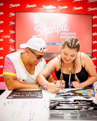 On the vibrant bus, fans made posters to hold up during their favorite musical performances. Elsewhere at the activation, Sharpie leaned into its tagline, “The world is your canvas,” with display cases of items like sneakers, wallets, and even the body of a bike decked out in designs made with Sharpies.