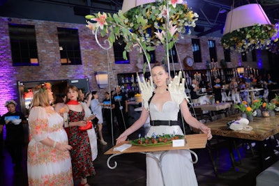 Servers circulated in fairy tale-style designs, including a dress with candlelit shoulders.