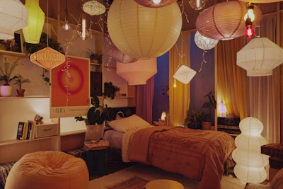 In the Room of Radiance, the decor included rice paper pendant lights, globe floor lamps, velvet beanbag chairs, and illuminated wall hangings. The glowing space showcased three Pinterest trends: vibey apartment, ambient lighting, and lamp aesthetic.