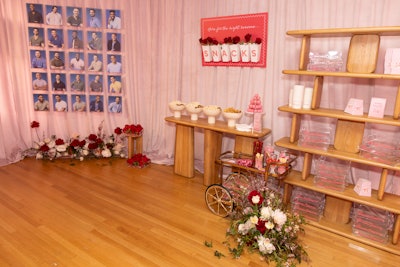 A snack station featured rose-adorned signage and individual branded snack trays.
