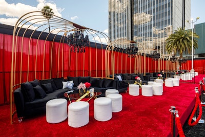 Drapes, of course, have practical purposes as well. For Guy Fieri's Walk of Fame celebration in 2019, bright red draping served as a perimeter and more aesthetically pleasing barrier for the event, which took place outside the Hollywood Palladium. Chad Hudson Events handled design and production for the colorful daytime gathering, while Revelry Event Designers handled decor, furniture, and draping.