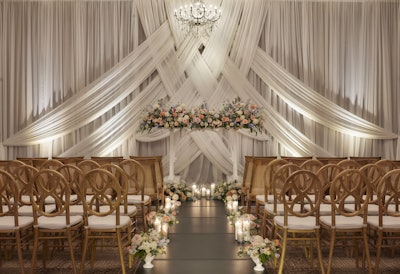 Along with adding warmth and elegance, drapes can make a statement at an event when they're expertly interwoven, like they were for this recent wedding ceremony.
