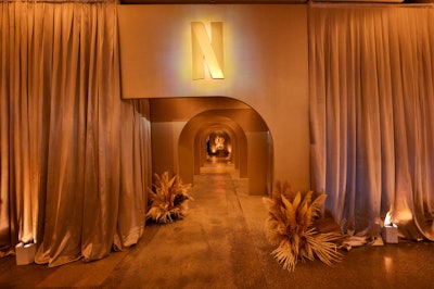 We're still thinking about Netflix's monochromatic masterpiece of an after-party following the 2022 Emmys. Best Events transformed a raw studio space into a posh tone-on-tone affair layered with shades of cream, champagne, and gold. The drapes, designed by Dazian, were no exception and helped set a dreamy mood at the entrance.