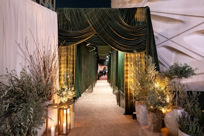 Drapes especially make an impression when they're rich in color. This look also comes from Disney's Emmys 2024 after-party, designed by Sterling Engagements, where a tunnel entrance moment featured a photographer who captured a portrait of each guest; attendees could scan a QR code to get their photos post-event. The enclosed entrance was covered by a dreamy olive velvet drape.