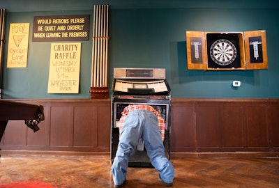 The space featured engagement opportunities such as playing a game of pool or darts, taking photos next to a chair barricade, visiting a zombie face-planted in a jukebox, or exploring a collection of hand-painted signage for the ultimate hidden-gem discovery. In a fun twist, faux windows showed videos of zombies actively trying to get into the bar.