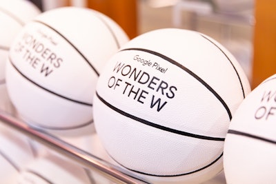 Customizable merch included these white branded basketballs.