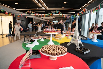 The event also had a French-themed dessert display arranged on tables representing the five Olympic rings. Surrounding an Eiffel Tower centerpiece, desserts included macarons, raspberry financiers, eclairs, pate de fruit, and mini mont blancs with chestnut, orange Chantilly cream, and chocolate.