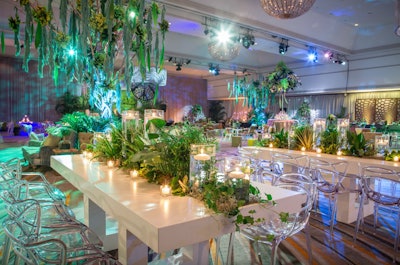 Fairmont Chicago was draped in shades of green via live plants and colored furnishings for the 2017 Pantone Color of the Year event, where Kehoe Designs helmed the event's design. Running with a greenery theme—Pantone's then-color of the year—the event design team incorporated appropriately colored products from the client's product line, such as green mop heads, which were used to form the oversized, makeshift weeping willow trees. Working with sister company Floral Exhibits, the team aimed to make it appear as if living plants were growing right out of the tables themselves.