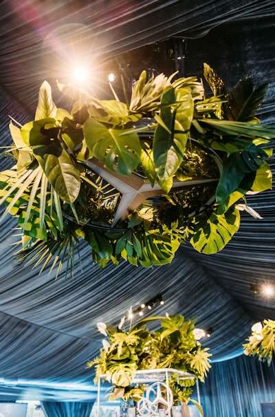 Mercedes-Benz hosted its 2022 Academy Awards viewing party at the Four Seasons Los Angeles in Beverly Hills. Designed and produced by Sterling Social, the glamorous gathering took a bold, masculine, and sleek approach, with a tonal color palette of black, pewter, and slate gray. As a focal point, four suspended 4-foot Mercedes-Benz logos—adorned with textured greenery—functioned as faux chandeliers hanging overhead. See more: Oscars 2022: Event Highlights From the Week's Most Glamorous Gatherings