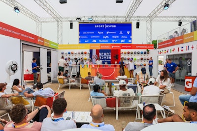 The activation, which was supported by more than 50 athlete partners and sponsors, included a bar area where attendees could watch the Euro 2024 soccer tournament. The bar featured a colorful wall of basketballs with custom designs.