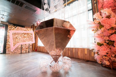 One of the main installations is a giant diamond floor piece, a nod to the diamonds held by The Real Housewives of Beverly Hills cast in the show’s title sequence. The event entrance also features a photo booth with a pink chat box akin to the Bravo logo. Selfie Booth Co. provided the event photo booths.