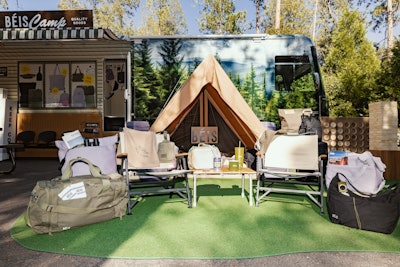 The pop-up features a classic camping setup with the new collection on display.