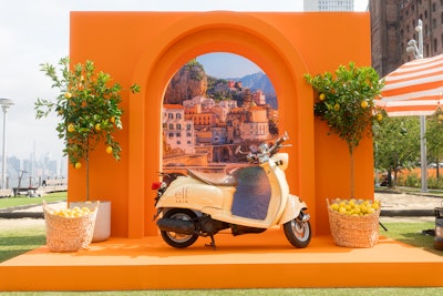This photo op took center stage, featuring a branded Vespa set in front of a picture of Positano's coastline.