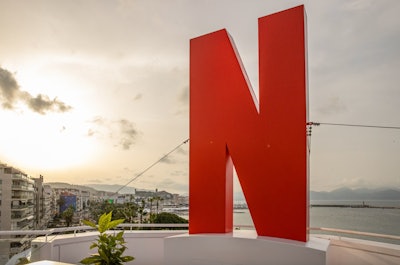 Netflix also opted for a huge, eye-catching logo during its first official appearance at Cannes Lions in 2023. The activation, a partnership with Seen Presents, took over a rooftop space at the JW Marriott—meaning the large 'N' was visible up and down the Croisette all week. See more: Cannes Lions 2023: 45 Steal-Worthy Event Ideas From the Massive Festival of Creativity