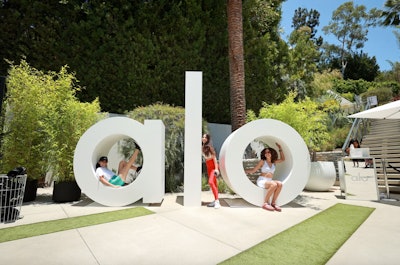 At yoga apparel brand Alo's four-day activation—held at a sprawling private residence in West Hollywood, Calif., in 2021—the team intended the design and production to provide irresistible social media moments at every turn, with details geared to the POV of the content creator. For example, influencers could hardly miss showcasing the brand’s message with towering white block letters spelling its name throughout the pool area and elsewhere around the property.