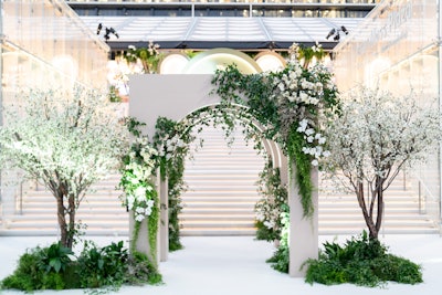 Sterling Engagements worked with Enso Creative on floral design and fabrication, including on this stunner of an entrance piece. 'The arrivals moment we wanted to keep very clean with neutrals to set the tone for the entrance and let guests and talent be our color,' says Rembac. 'We integrated white blossom trees alongside smilax, magnolia, white cherry blossoms, and calcynia.'