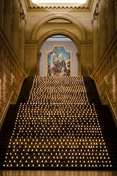 A display of 1,200 votive candles lined the stairs in the Great Hall at The Metropolitan Museum of Art at the opening night party for Bullets Over Broadway in New York in 2014, greeting the 900 guests as they arrived from the St. James Theatre. See more: Why 'Bullets Over Broadway' Took Over the Met