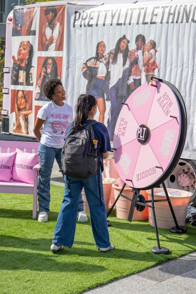 At the “Spin the Wheel” prize station, students can win merch and vouchers.