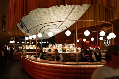 For a party for Uber during Super Bowl LVIII week, designer David Stark used a giant football to create a unique and memorable ceiling moment.