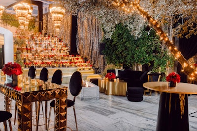Warner Bros. effectively evoked the magic of Tinseltown with its 2023 Oscars event. Drawing 350 guests, the glamorous gathering had an over-the-top event design from JOWY Productions, which leaned into a mix of black and gold with accents of red—and, of course, plenty of sparkle. Over 300 glass hurricane candles filled with black sand flickered throughout the party, juxtaposed with twinkle lights in the trees. As a focal point, a tiered candle installation featured 5-foot crystal and gold chandeliers. See more: Oscars 2023: Elegant Event Inspiration From Hollywood's Most Glamorous Week
