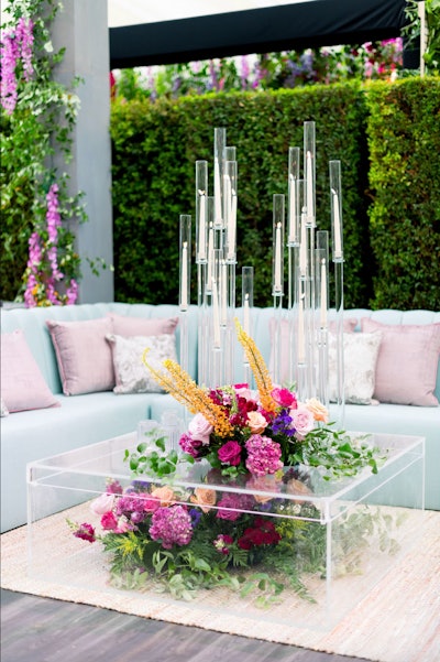 At Disney’s 2022 Emmys party, designed and produced by Sterling Engagements, candles played a subtle yet impactful role in the 'modern botanic brilliance' theme. Surrounded by lush garden blooms and shimmering jewel tones, the candles added a soft, elegant glow that enhanced the chic botanical garden vibe without overshadowing the stunning floral arrangements. See more: Emmys 2022: Inside Parties From Netflix, Disney, Paramount, and More