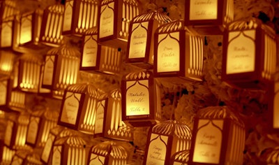 Engage!13, a luxury wedding summit, took place at Scottsdale's Montelucia Resort & Spa in December 2013. Playing off the venue's Moroccan-inspired architecture, designers from Gifts for the Good Life crafted birdcage lanterns to use as escort cards. Guests plucked the glowing lanterns off a live hydrangea wall that Todd Events erected for the closing night gala. Each lantern was marked with a guest's name and table number.
