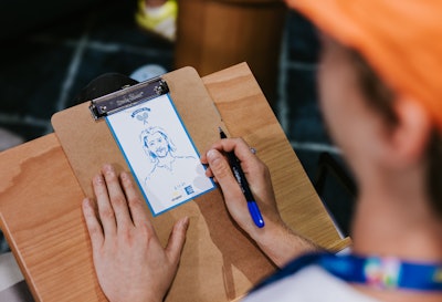 The second level of the Fan Experience boasted a Card Member Lounge, where guests could get a live portrait sketch courtesy of local artist Zac Crawford, known as “The Artist Zac,” as well as painter and YouTuber SLEW.