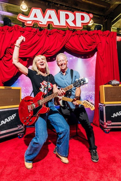 Or strap on a guitar and stand in front of a stage backdrop, complete with branded touring trunks.