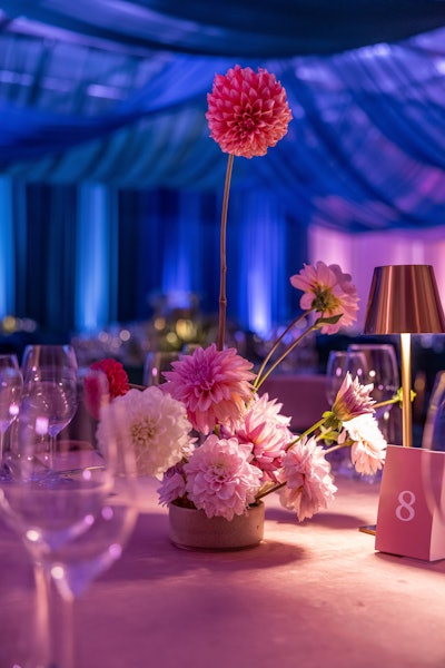 The space came alive with tones of dusty rose, champagne, hunter green, and royal blue that were perfectly matched in the abstract ceiling drape, wall perimeter, table cloths, napkins, menus, and florals.