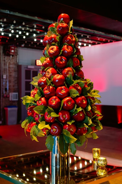 Overall, the event used a mix of real and faux apples totaling over 2,200 apples. These were on trees and topiaries as well as mixed into the floral arrangements.
