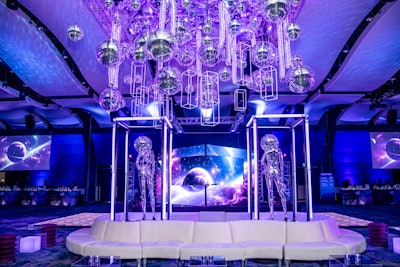 The center room featured a collage of disco balls, space tubes, and spheres that hovered above guests’ heads. This was enhanced by a custom platform that rotated with futuristic disco-inspired mannequins.