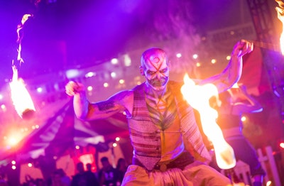 The Queen Mary’s Dark Harbor has returned to Long Beach, Calif., after a four-year pandemic-related closure. Produced by Thirteenth Floor Entertainment Group for the first time this year, the massive Halloween festival features spooky speakeasies, mazes, carnival rides, and other attractions both on and off the historic boat, along with nightly entertainment like fire spinners, magicians, and sideshow performers.