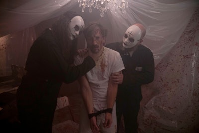In The Purge series, the government sanctions an annual 12-hour period during which all criminal activity including murder is legal. The 'Overnightmare' experience featured masked characters similar to those in the films.