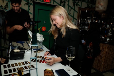 The evening included a cocktail reception where guests mingled over signature drinks, plus an activation allowing attendees to personalize leather card holders with gold-foiled signatures—a nod to the ECOA's themes of credit and equality. Wallets came from Royce and calligraphy came from That Saturday.
