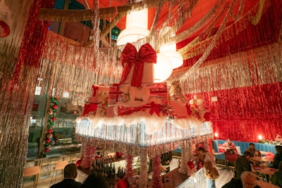 The New York pop-up includes a festive bar as the event centerpiece, topped with oversize presents and stuffed animals.
