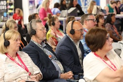 Audience members listened to speakers at Connect Marketplace 2024 with Implecho Headsets.