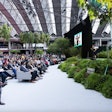 Money20/20 Europe's stunning Na.i.ture Stage was originally conceived with a tree canopy to provide shade from the glass ceiling. The nature theme was then used to tie into the broader 2024 event theme of 'Human x Machine,' with the team imagining what a tree- and plant-based stage design would look like if created by an AI. All plants were replanted in local greenhouses after the show.