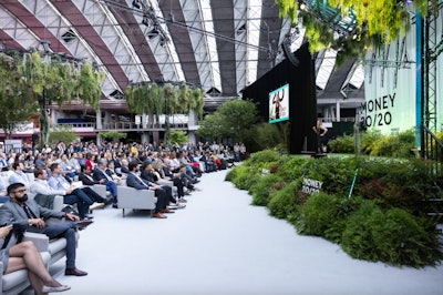 Money20/20 Europe's stunning Na.i.ture Stage was originally conceived with a tree canopy to provide shade from the glass ceiling. The nature theme was then used to tie into the broader 2024 event theme of 'Human x Machine,' with the team imagining what a tree- and plant-based stage design would look like if created by an AI. All plants were replanted in local greenhouses after the show.